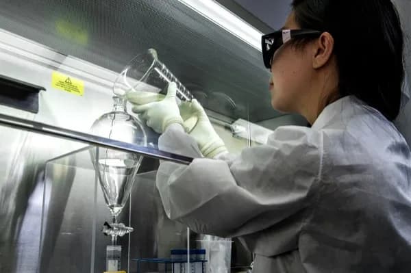 Scientist handling separating funnel